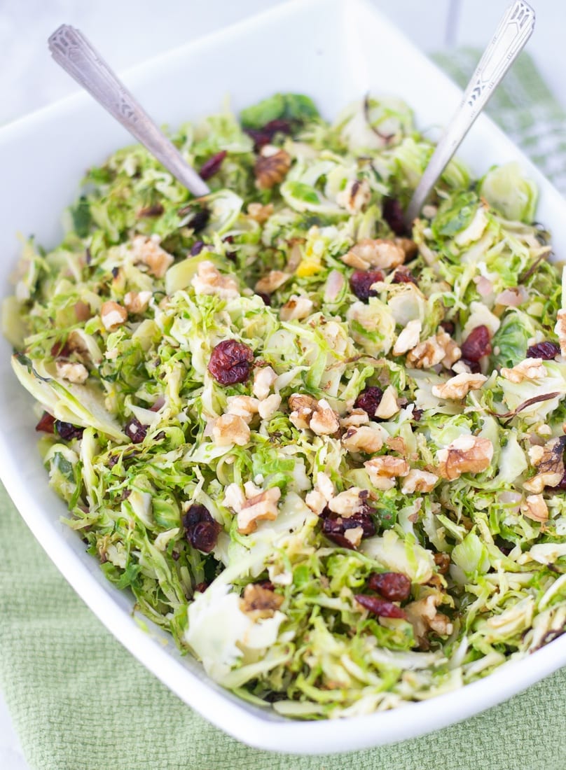 Cranberry Orange Brussels Sprouts Slaw is an easy and healthy side dish recipe to enjoy with your next dinner. Brussels sprouts salad is shaved brussels sprouts tossed with cranberries and walnuts in an orange dressing. #cranberry #brussselssprouts #shavedbrusselssprouts #walnuts #cranberryorange #paleorecipe #whole30 #healthysidedish