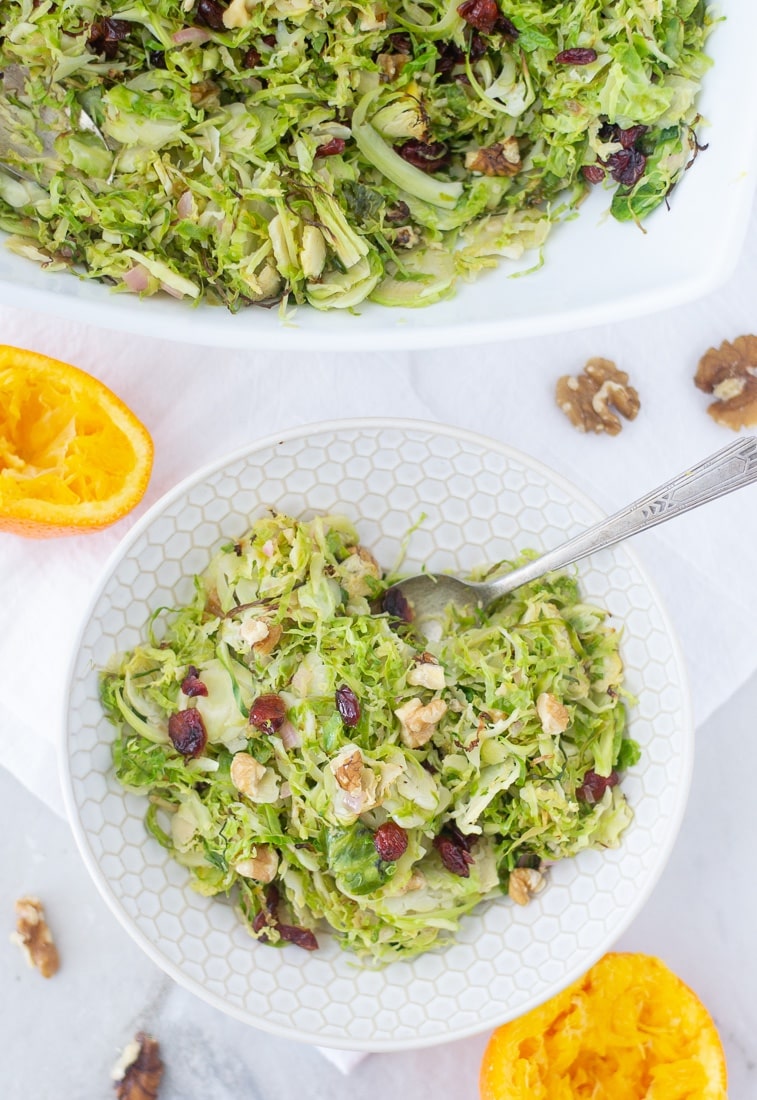 Cranberry Orange Brussels Sprouts Slaw is an easy and healthy side dish recipe to enjoy with your next dinner. Brussels sprouts salad is shaved brussels sprouts tossed with cranberries and walnuts in an orange dressing. #cranberry #brussselssprouts #shavedbrusselssprouts #walnuts #cranberryorange #paleorecipe #whole30 #healthysidedish
