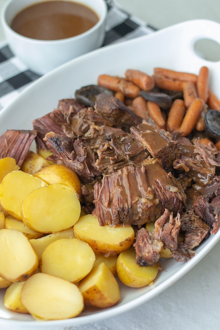 Slow cooker pot roast is the best weeknight dinner recipe for busy families. This easy pot roast recipe is made with a red wine sauce that makes the most amazing gravy after the pot roast cooks in the crockpot. #redwine #potroast #slowcooker #familyrecipe