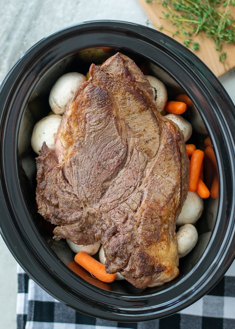 Slow cooker pot roast is the best weeknight dinner recipe for busy families. This easy pot roast recipe is made with a red wine sauce that makes the most amazing gravy after the pot roast cooks in the crockpot. #redwine #potroast #slowcooker #familyrecipe