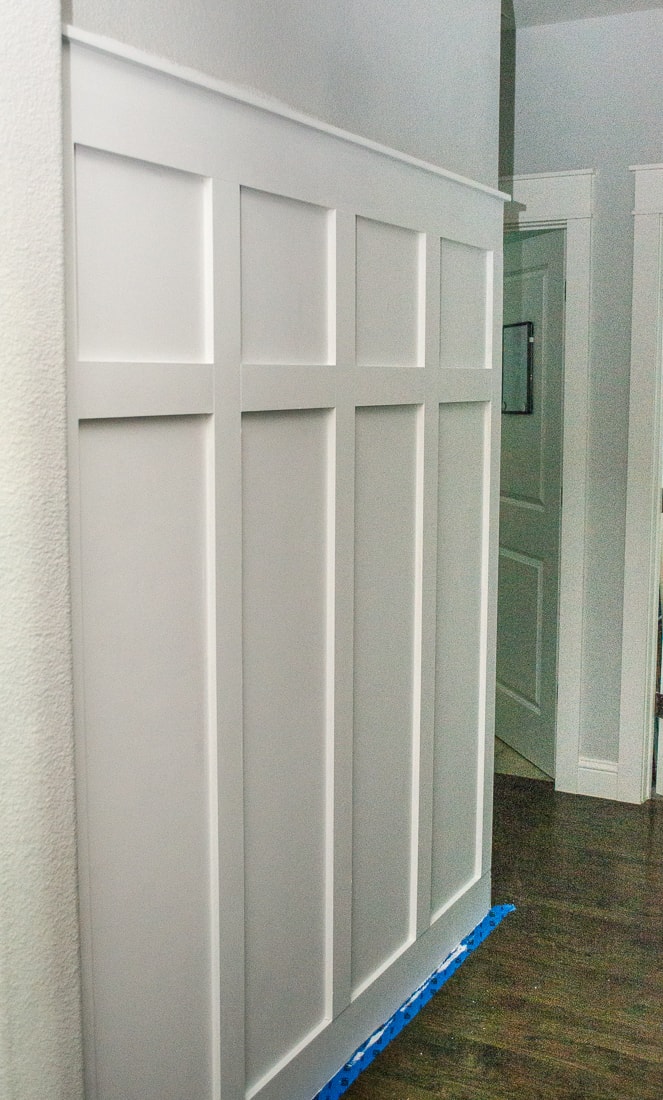 A step by step guide to installing a board and batten molding wall in a hallway with hooks to act as a mudroom. This DIY trim can add a little farmhouse decor to a boring space! #molding #diyproject