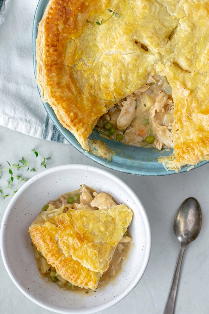Easy to make Turkey Pot Pie Recipe with loads of veggies and leftover chicken or turkey. The crust is a flakey puff pastry which makes if a quick a delicious weeknight dinner. #potpie #turkeyleftovers
