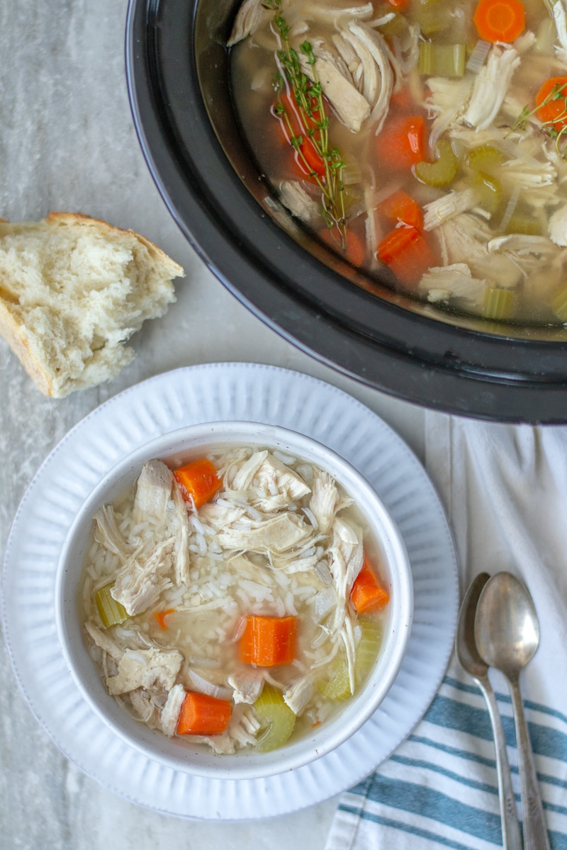 Crockpot chicken and rice soup is an easy set and forget homemade dinner that is heathy and delicious. Learn how to make it on the stovetop as well! #chickendinner #healthyreceipe