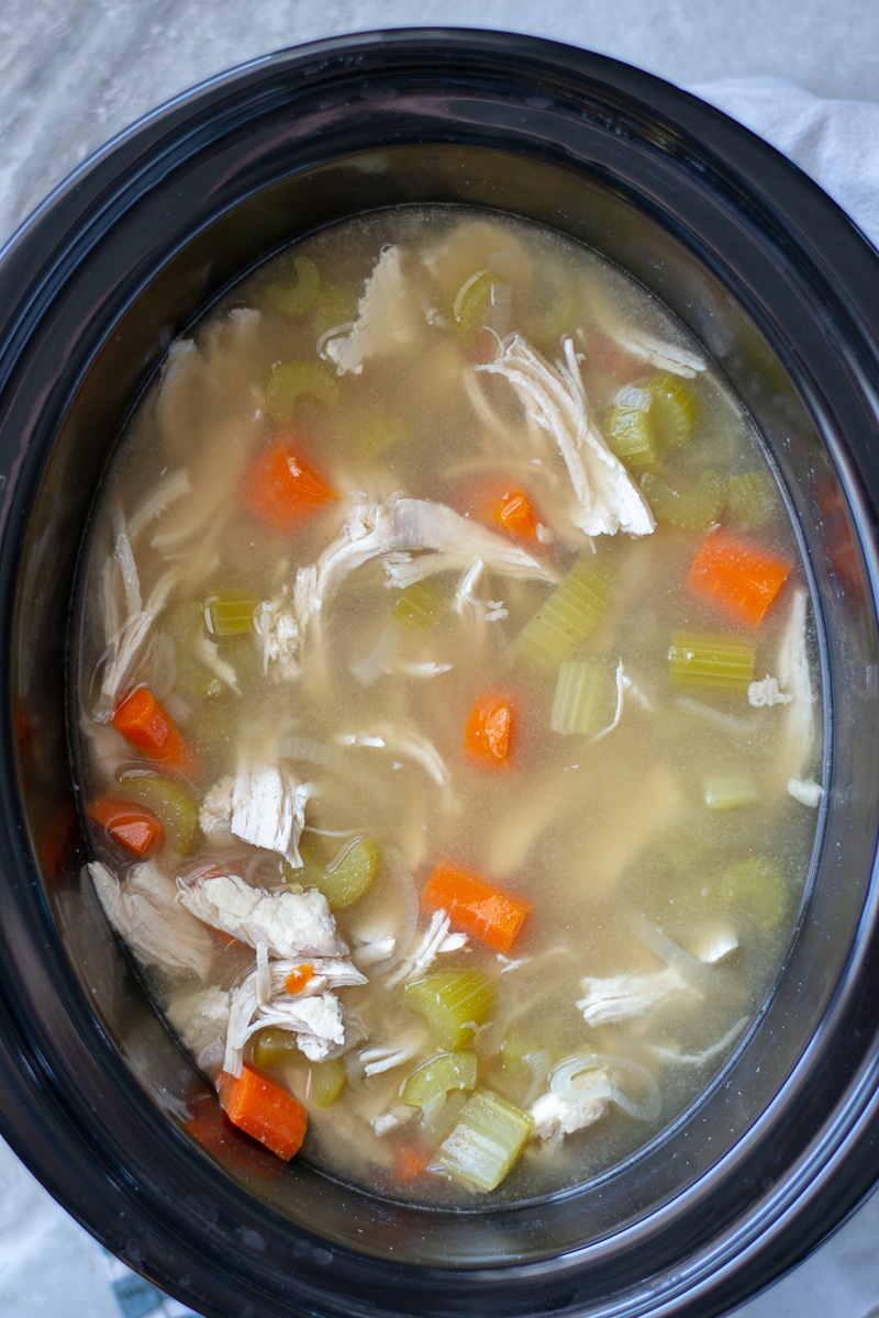 Crockpot chicken and rice soup is an easy set and forget homemade dinner that is heathy and delicious. Learn how to make it on the stovetop as well! #chickendinner #healthyreceipe