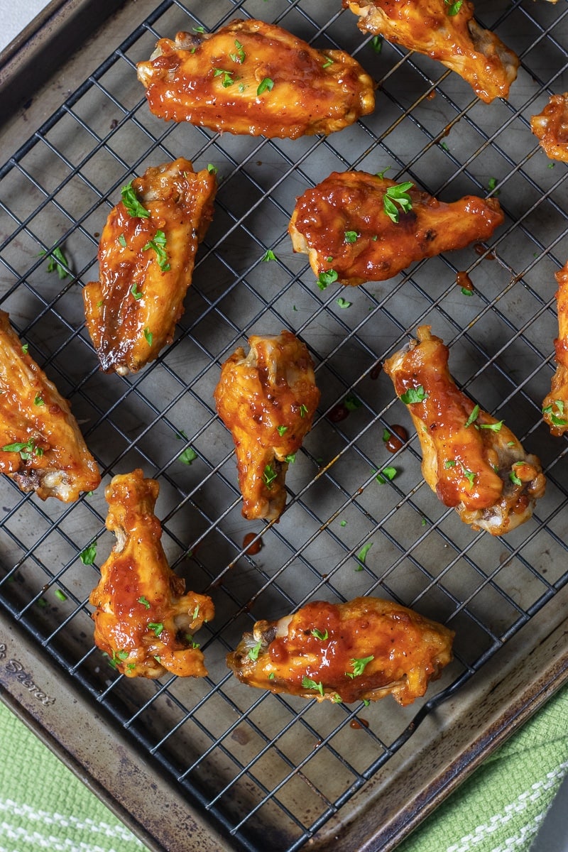 Healthier baked chicken wings are cooked in the oven until crispy and coated with a homemade sweet and spicy honey chipotle barbecue sauce. Bring these to your Super Bowl party and everyone will love them!