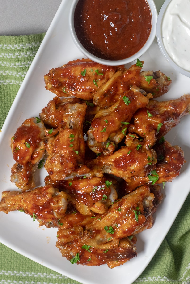 Healthier baked chicken wings are cooked in the oven until crispy and coated with a homemade sweet and spicy honey chipotle barbecue sauce. Bring these to your Super Bowl party and everyone will love them!