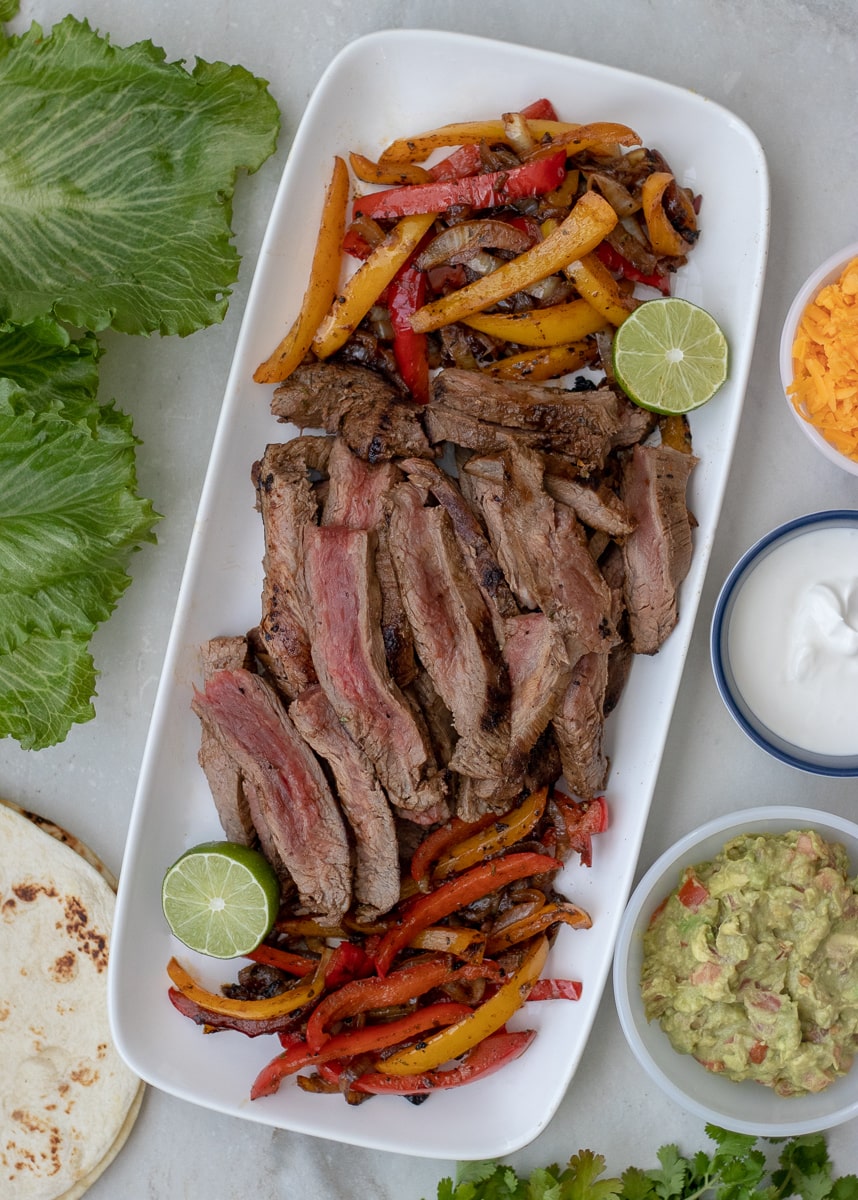 Pan seared flank steak fajitas marinated in a smokey citrus steak fajita marinade. Serve over greens or in lettuce boats to make them Whole30 and Paleo approved. 