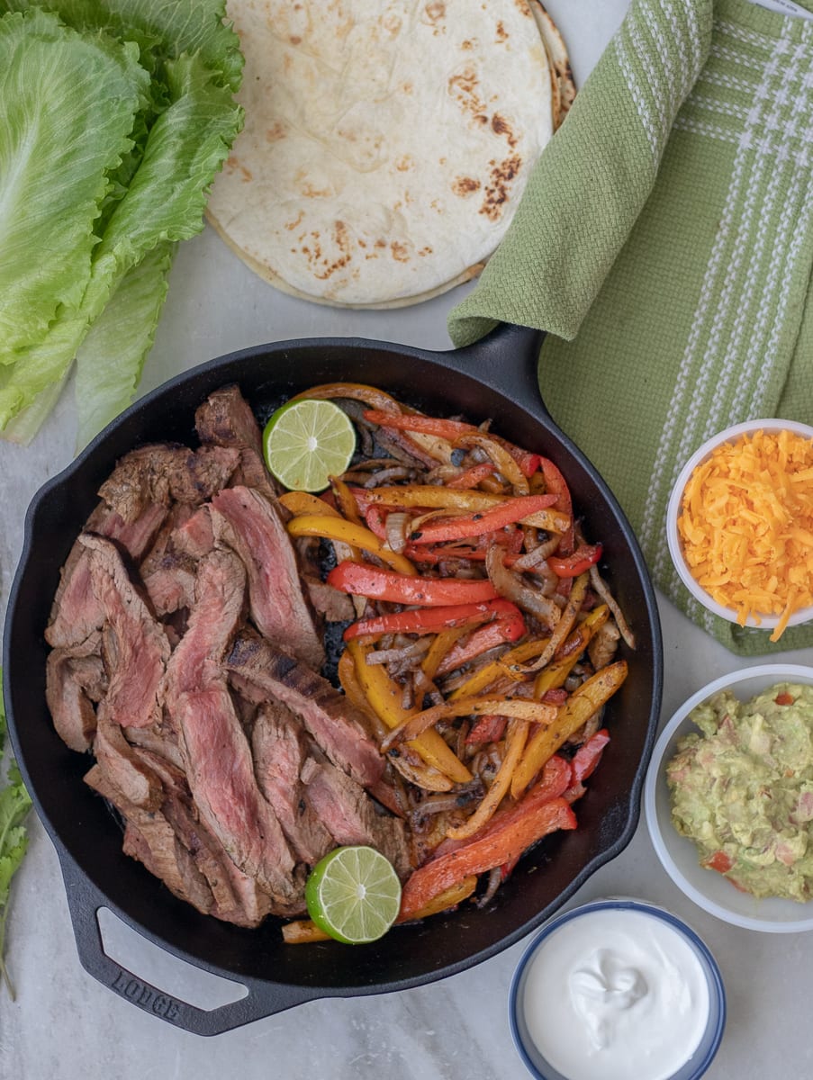 Pan seared flank steak fajitas marinated in a smokey citrus steak fajita marinade. Serve over greens or in lettuce boats to make them Whole30 and Paleo approved. 