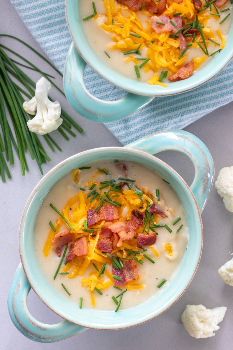 Healthier Loaded Potato and cauliflower soup is great way to get kids to eat the cauliflower they won't eat on it's own! Cauliflower, potatoes, onion and garlic are pureed to creamy goodness all in one pot!