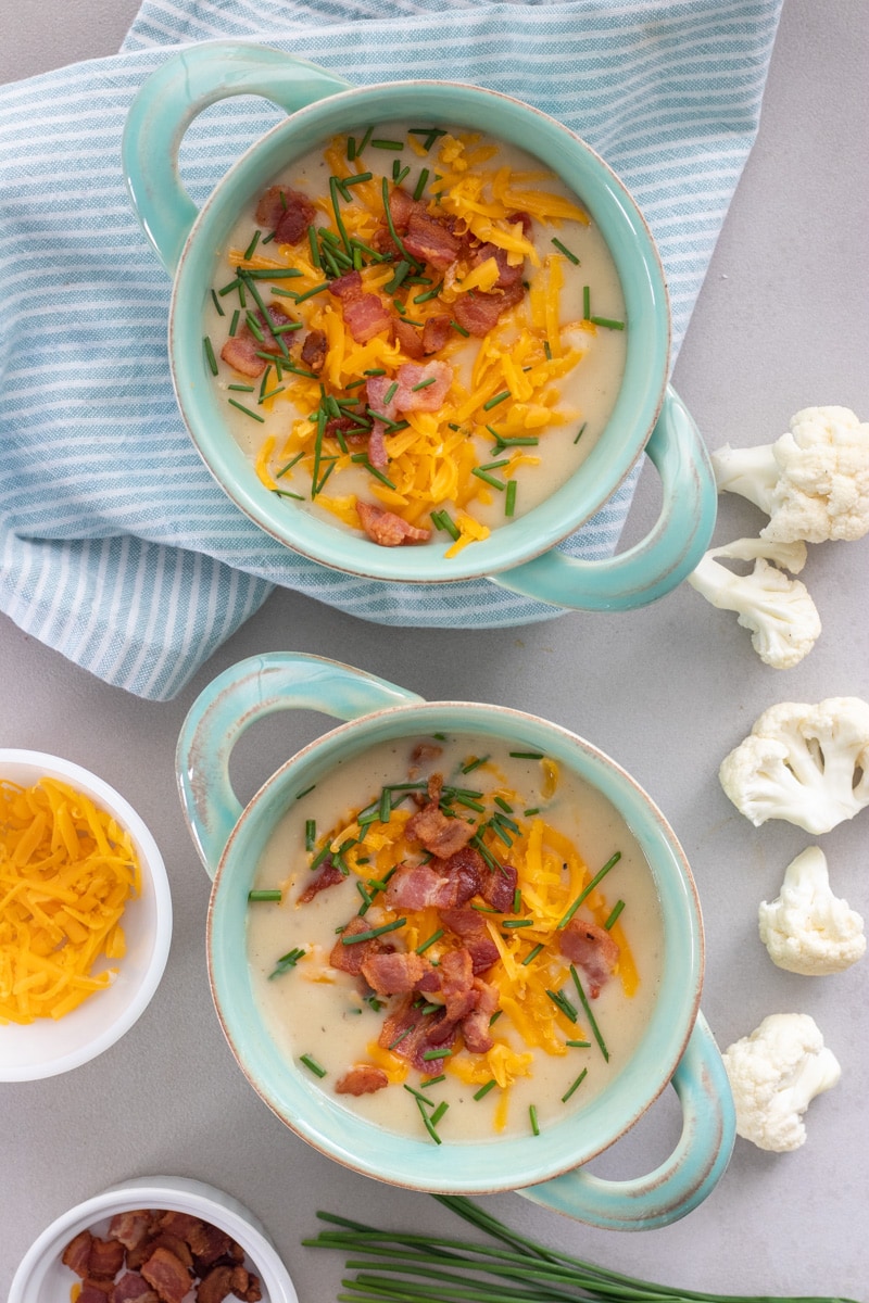 Healthier Loaded Potato and cauliflower soup is great way to get kids to eat the cauliflower they won't eat on it's own! Cauliflower, potatoes, onion and garlic are pureed to creamy goodness all in one pot!