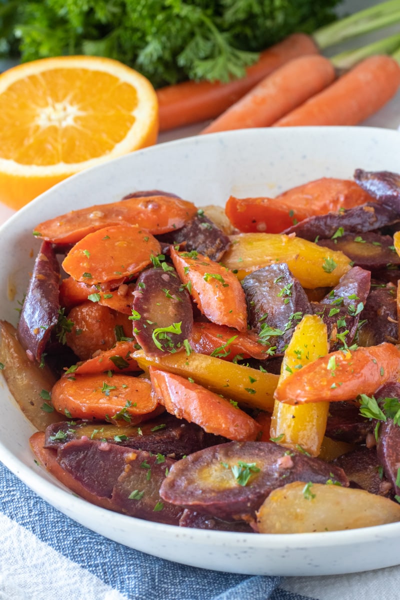 Serving sweet roasted carrots with parsley on top. 