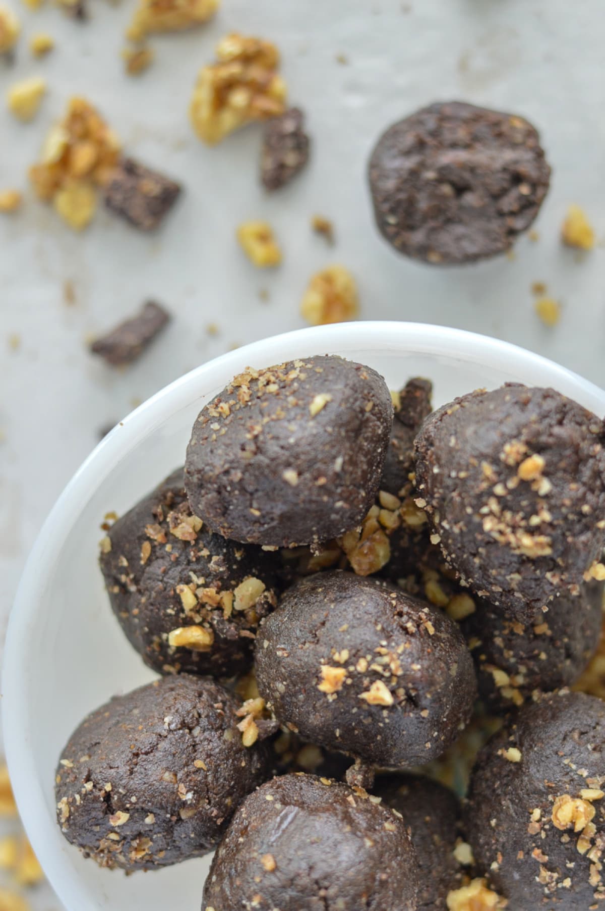 Brownie batter protein bites are the perfect paleo snack with nut butter, coconut oil, collagen, and dates. 