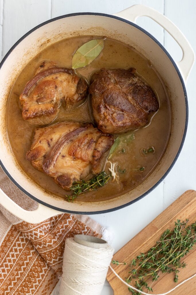 After pan-searing the pork should it will braise with liquids and herbs until it is tender. 