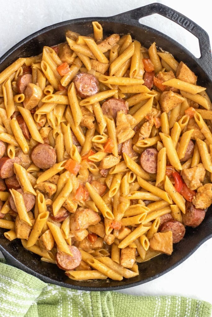 How to make a quick cajun chicken and sausage pasta dinner in one skillet in under 30 minutes. Perfect for a high protein meal prep or a weeknight dinner for the family. 