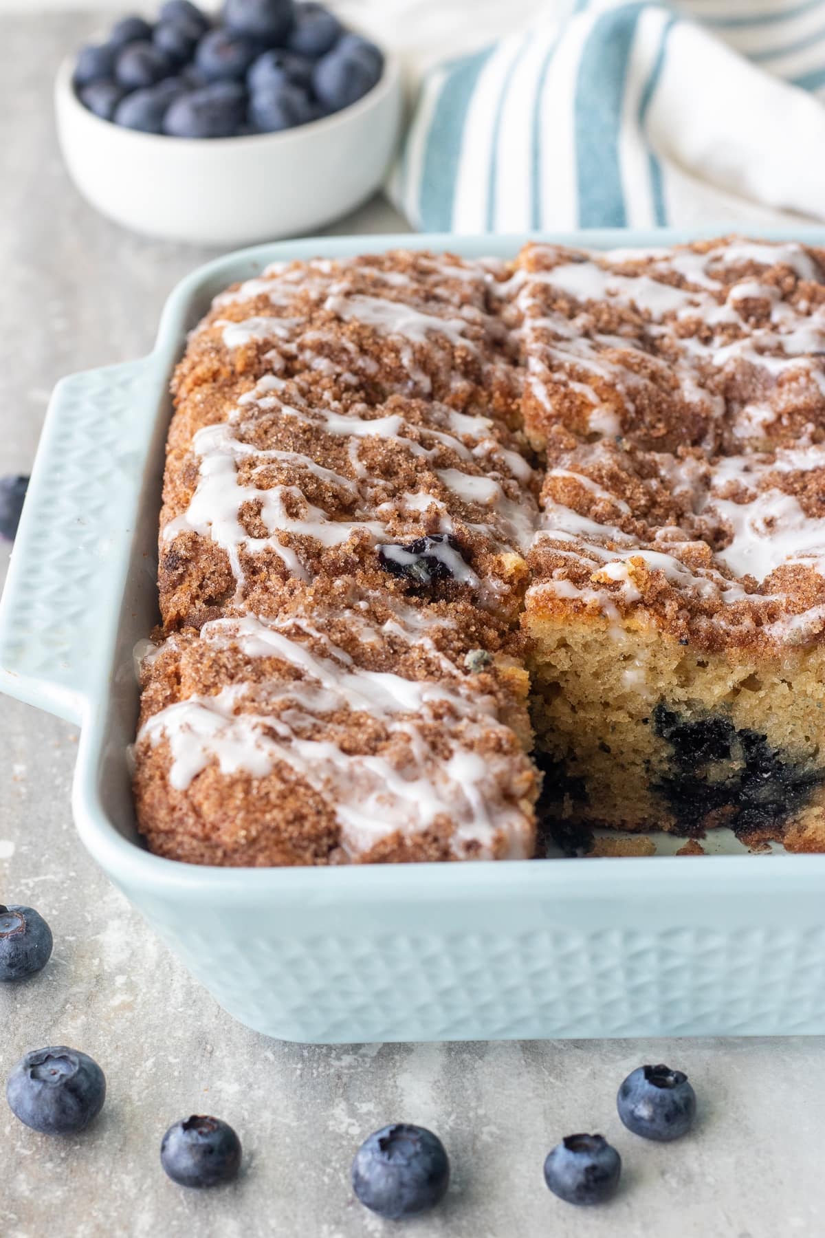 Fluffy sour cream coffee cake bursting with blueberries and topped with a cinnamon streusel and classic icing to make an indulgent brunch or dessert. 