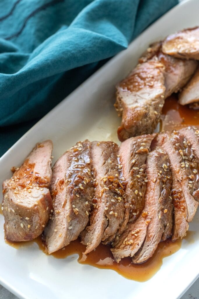 Honey sesame pork tenderloin is pan seared and coated in a sticky honey sesame sauce and finished in the oven to make it tender and flavorful. 