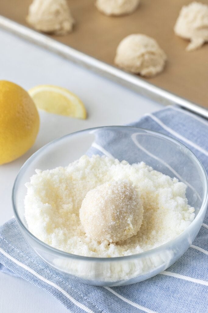 Process ½ cup of sugar with 1 teaspoon lemon zest and coat the dough balls in the mixture. 