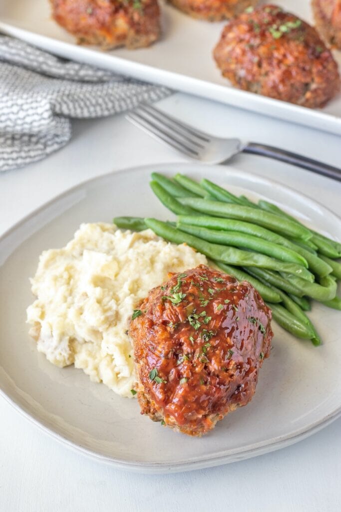 Serve mini meatloaves with mashed potatoes and steamed green beans. 