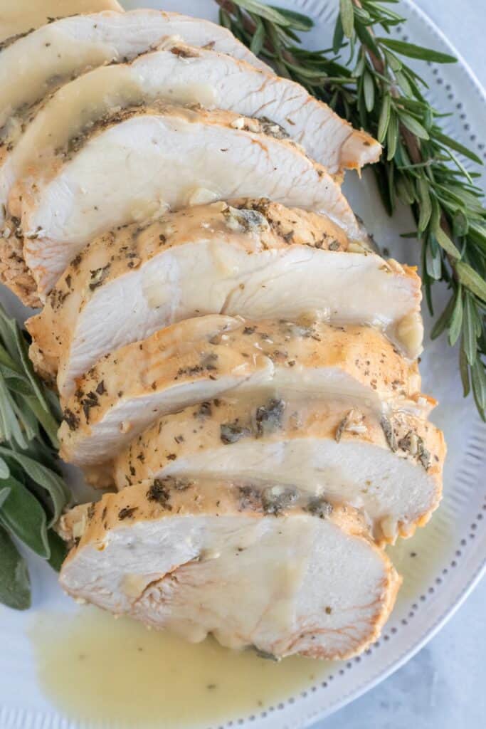 Sliced herb butter roasted turkey breast with gravy. 